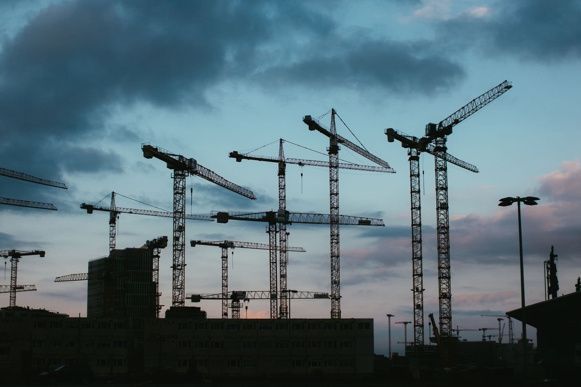 Tower cranes on a construction site at dusk